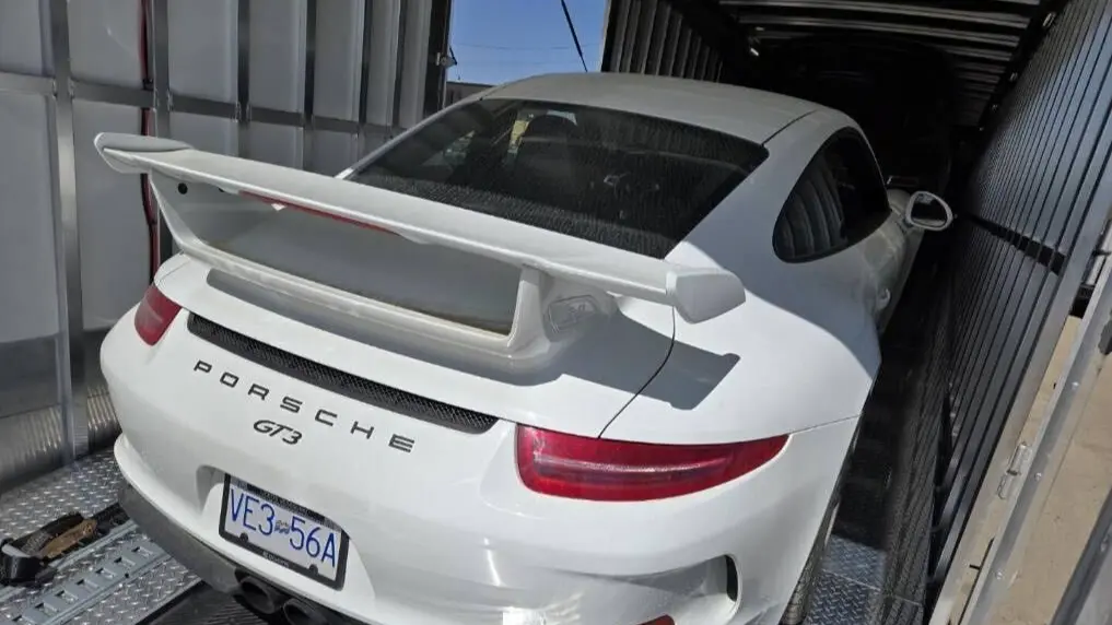 Enclosed car shipping truck providing protected transport