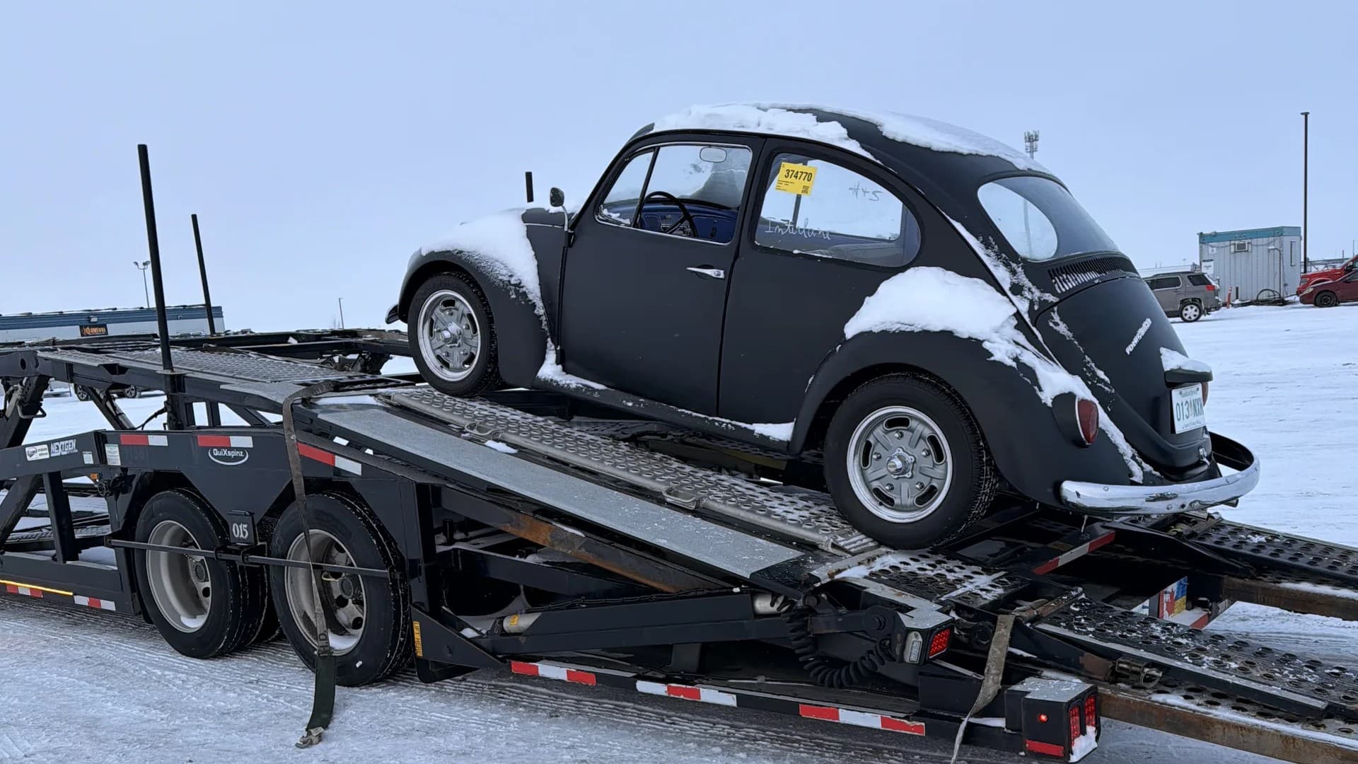 Vehicle being loaded onto open car carrier