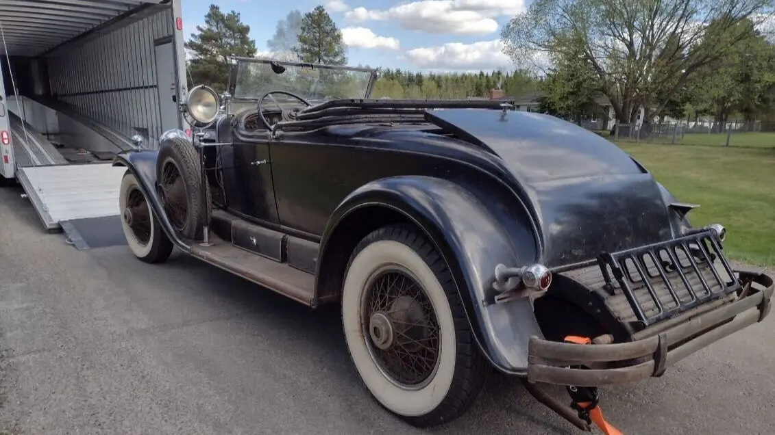 Classic convertible car on an open transport trailer