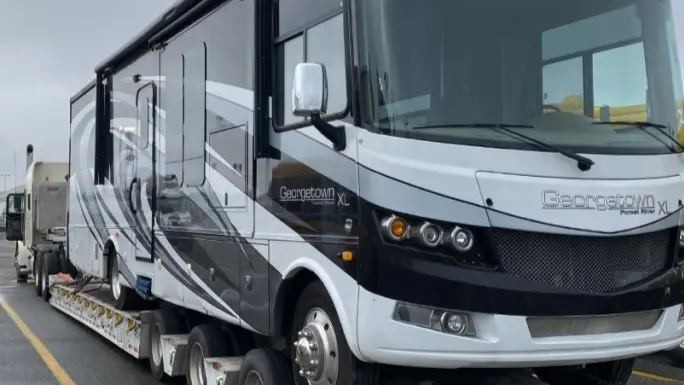 Large RV parked outdoors, ready for cross-country shipping