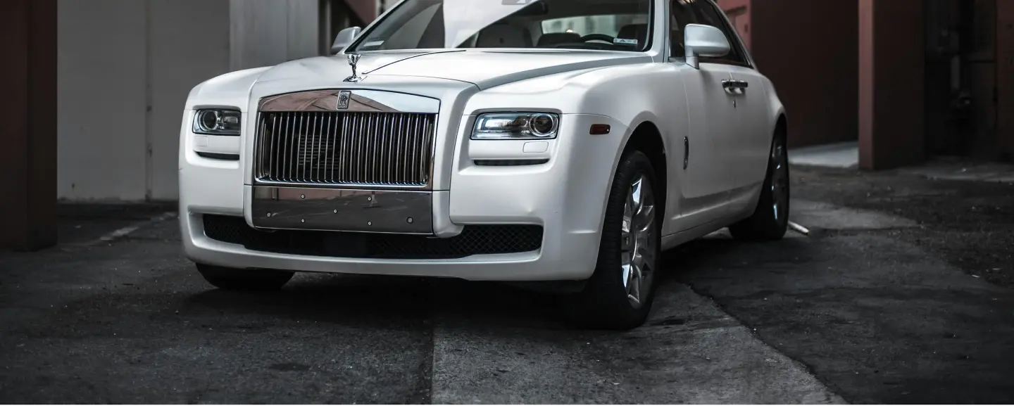 Luxury car being loaded into an enclosed trailer for transport