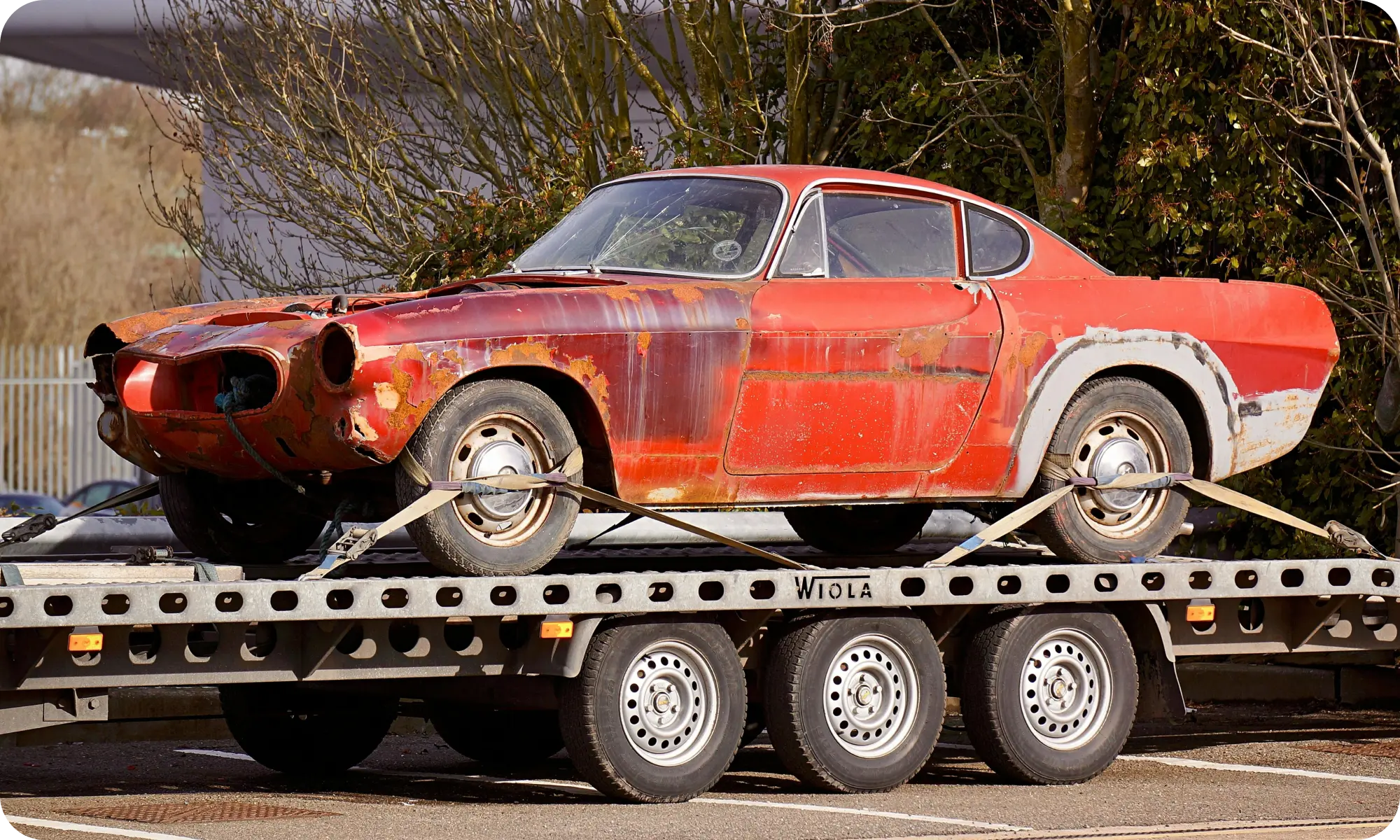 Non-operational vehicle loaded onto a flatbed for long-distance shipping