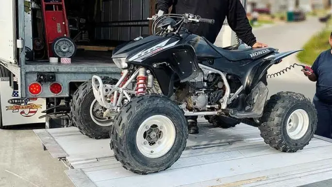 ATV being loaded onto a trailer for offroad vehicle transport