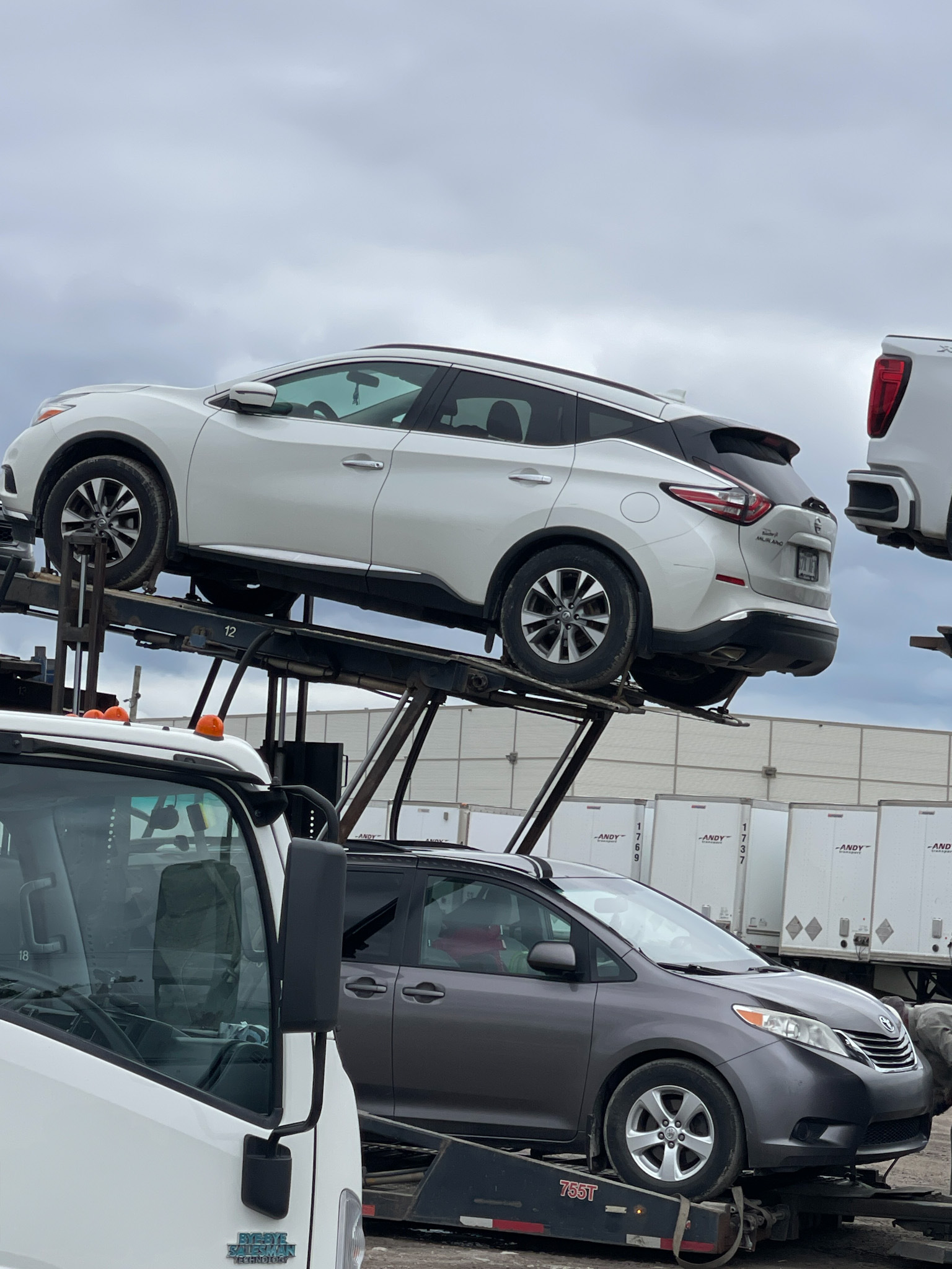 Auto transport carrier driving through Newfoundland toward ferry routes