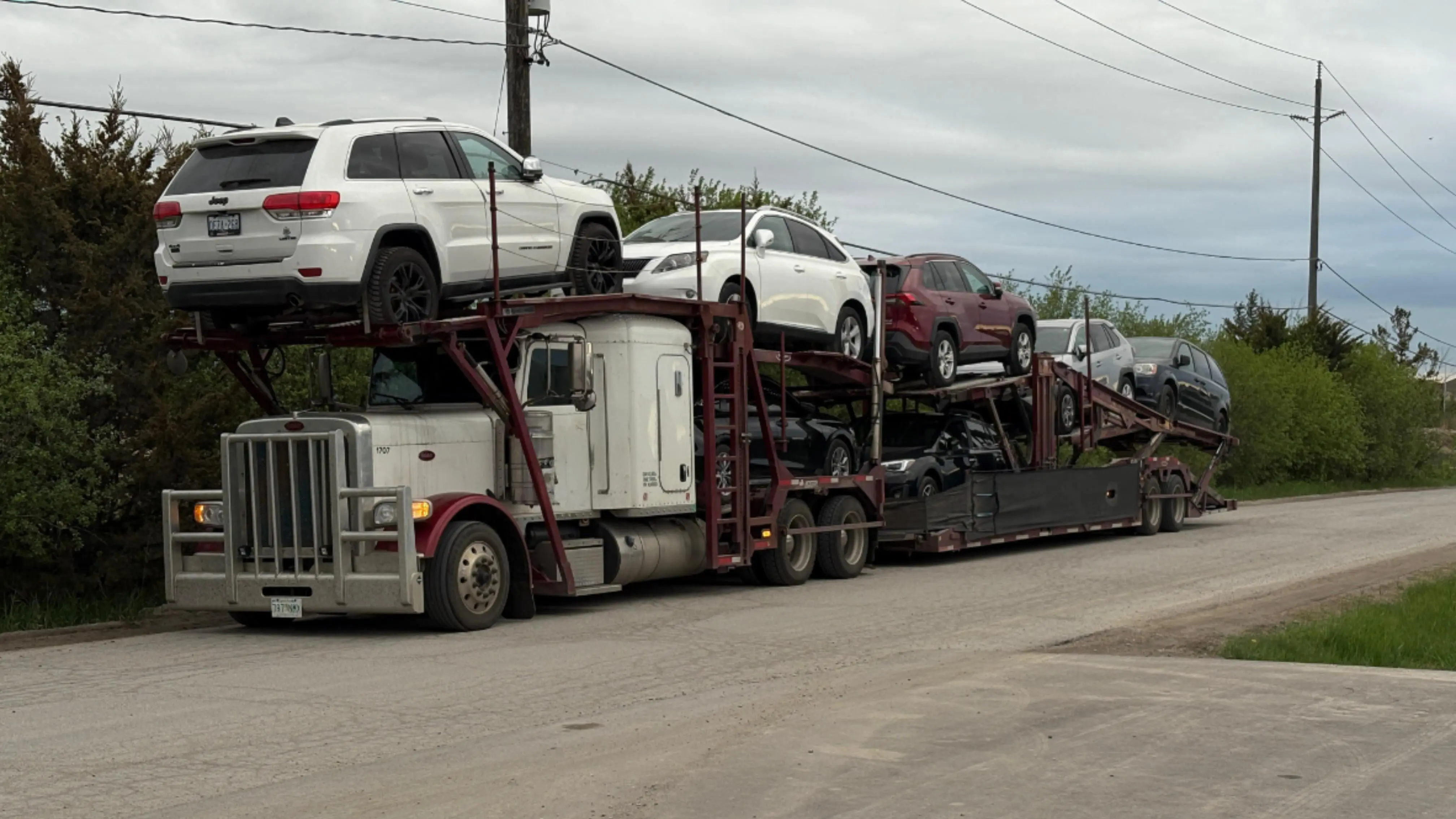 Car shipping truck in Nova Scotia near the ocean, transporting vehicles safely