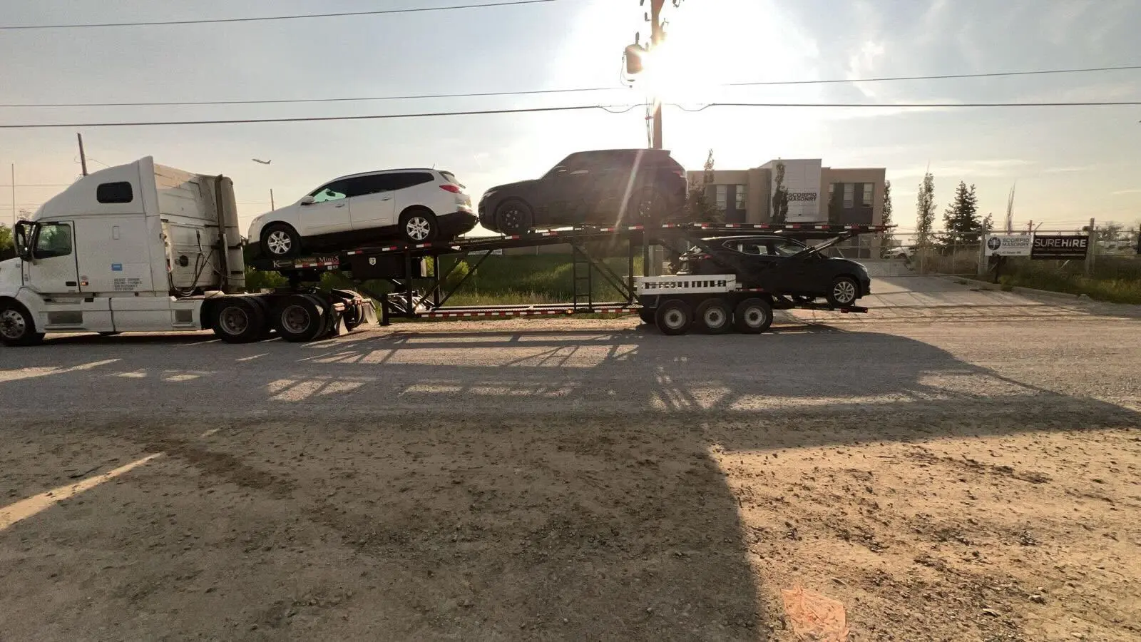 Car transport truck driving across a rural bridge in Prince Edward Island