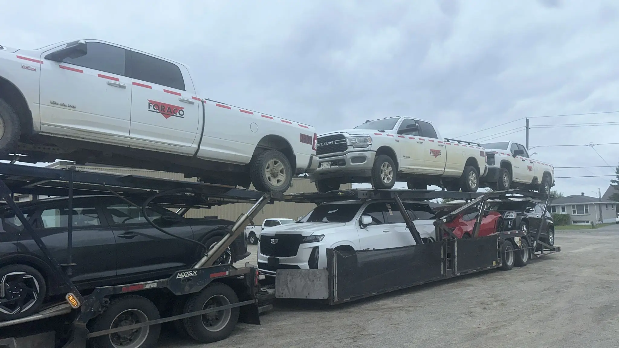 Vehicle transporter driving through scenic Quebec road