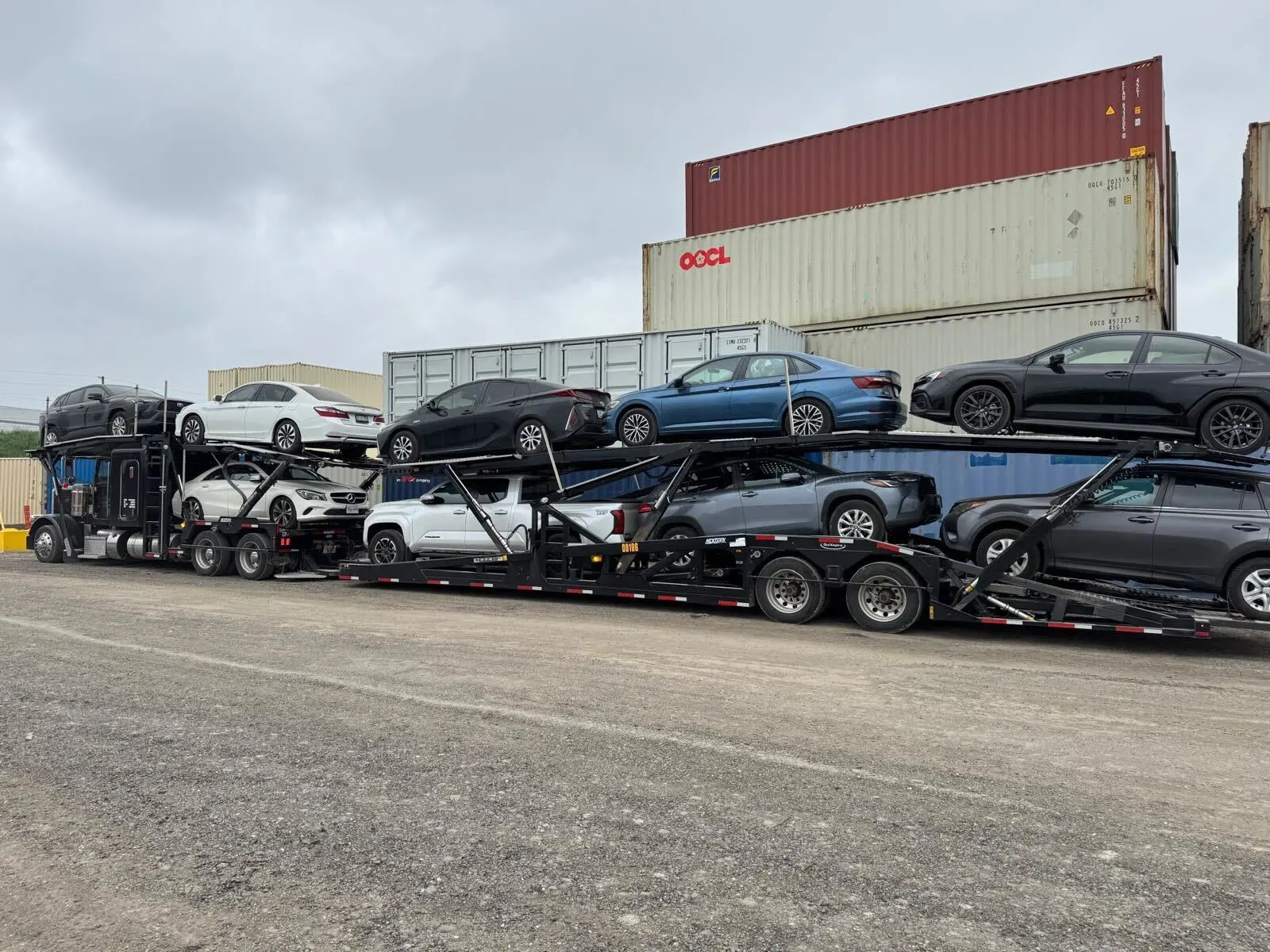Transport truck driving through Saskatchewan plains with vehicle load