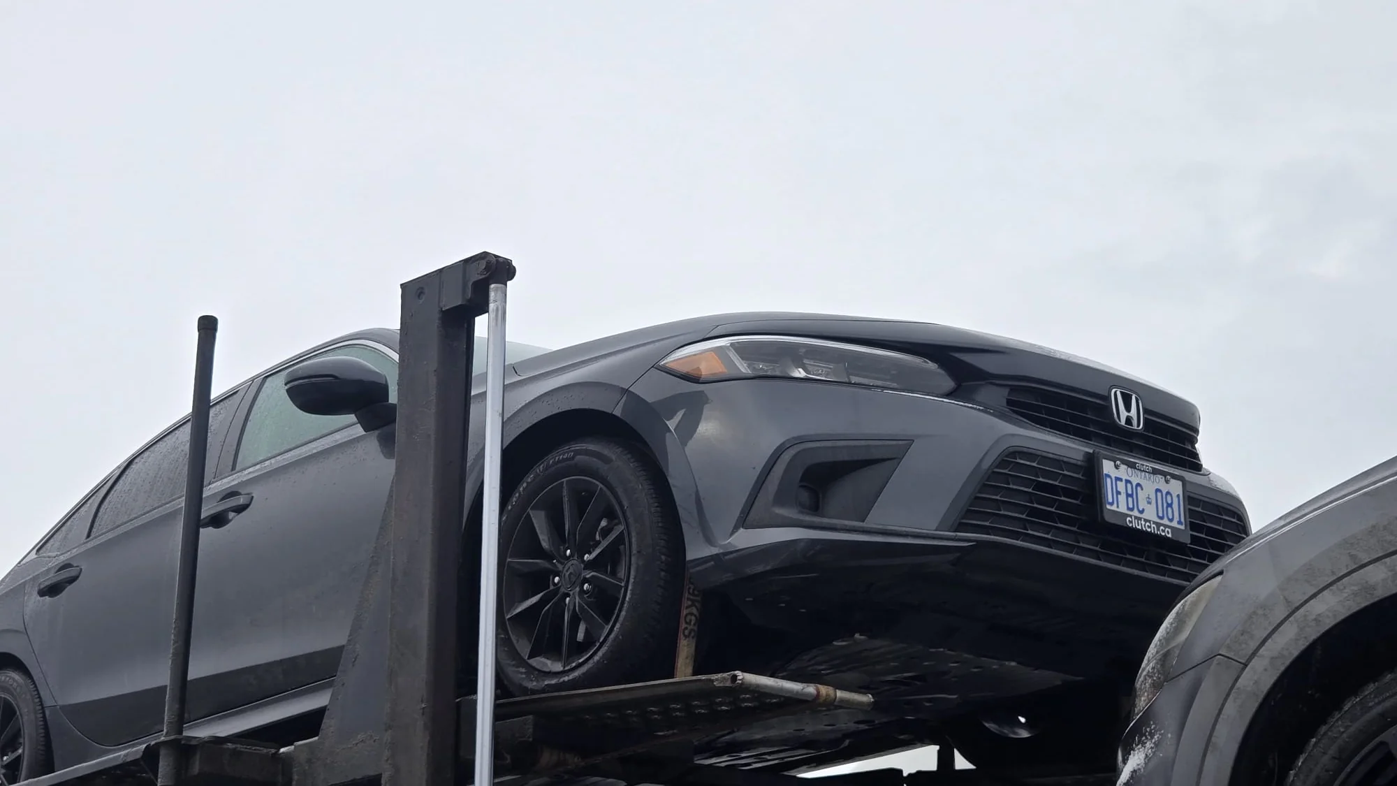 Vehicle being transported from Ontario to Alberta on an open carrier