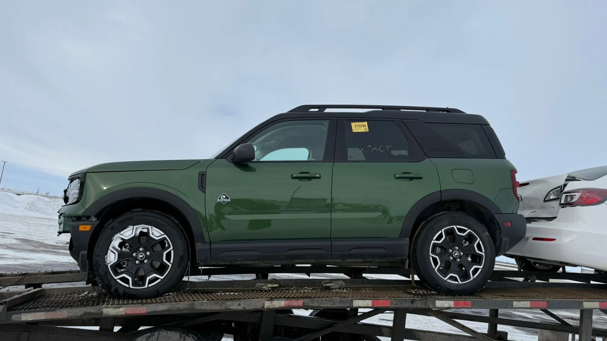 Vehicle being transported from Brampton to Hamilton via the QEW corridor