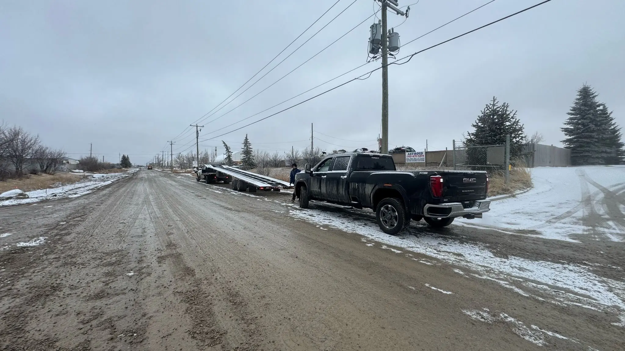 Open car carrier hauling vehicles through Canadian Rockies