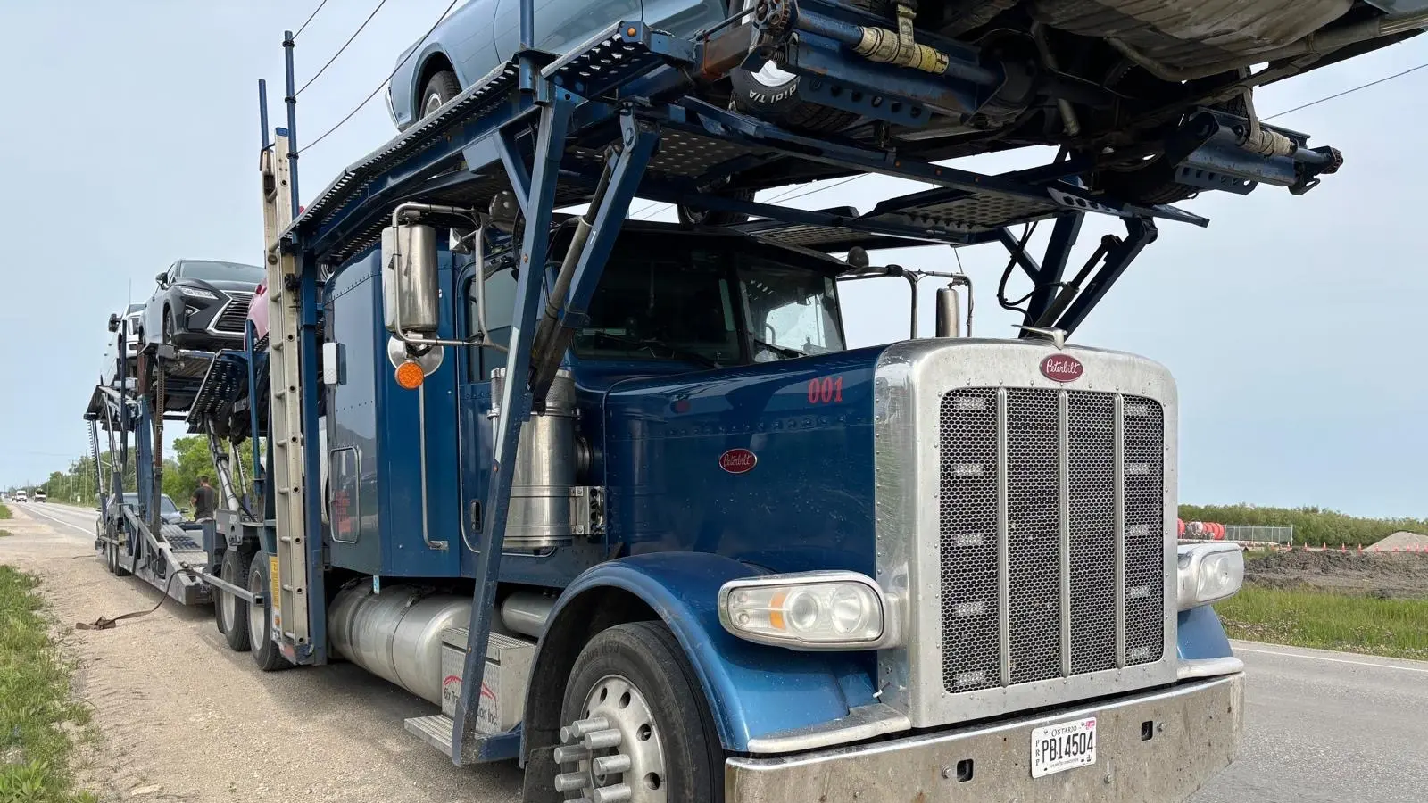 Vehicle loaded on an open trailer leaving Calgary
