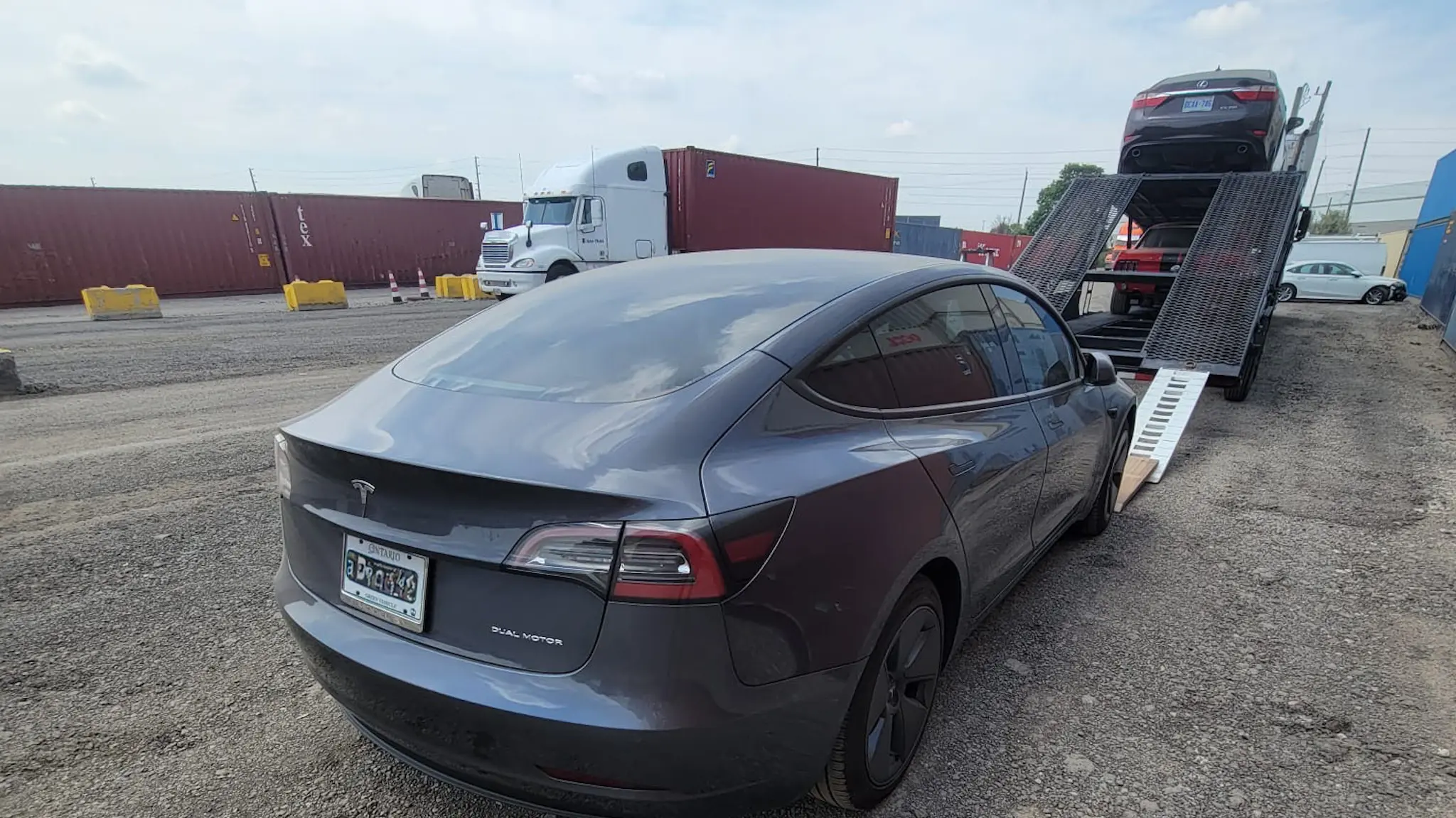 Open car hauler transporting multiple vehicles
